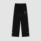 Pantalones deportivos con diseño de botones coloridos