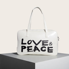 Bolso cuadrado pequeño con un solo hombro y estampado en blanco y negro