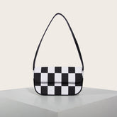 Bolso pequeño cuadrado de rejilla en blanco y negro con un solo hombro debajo del brazo